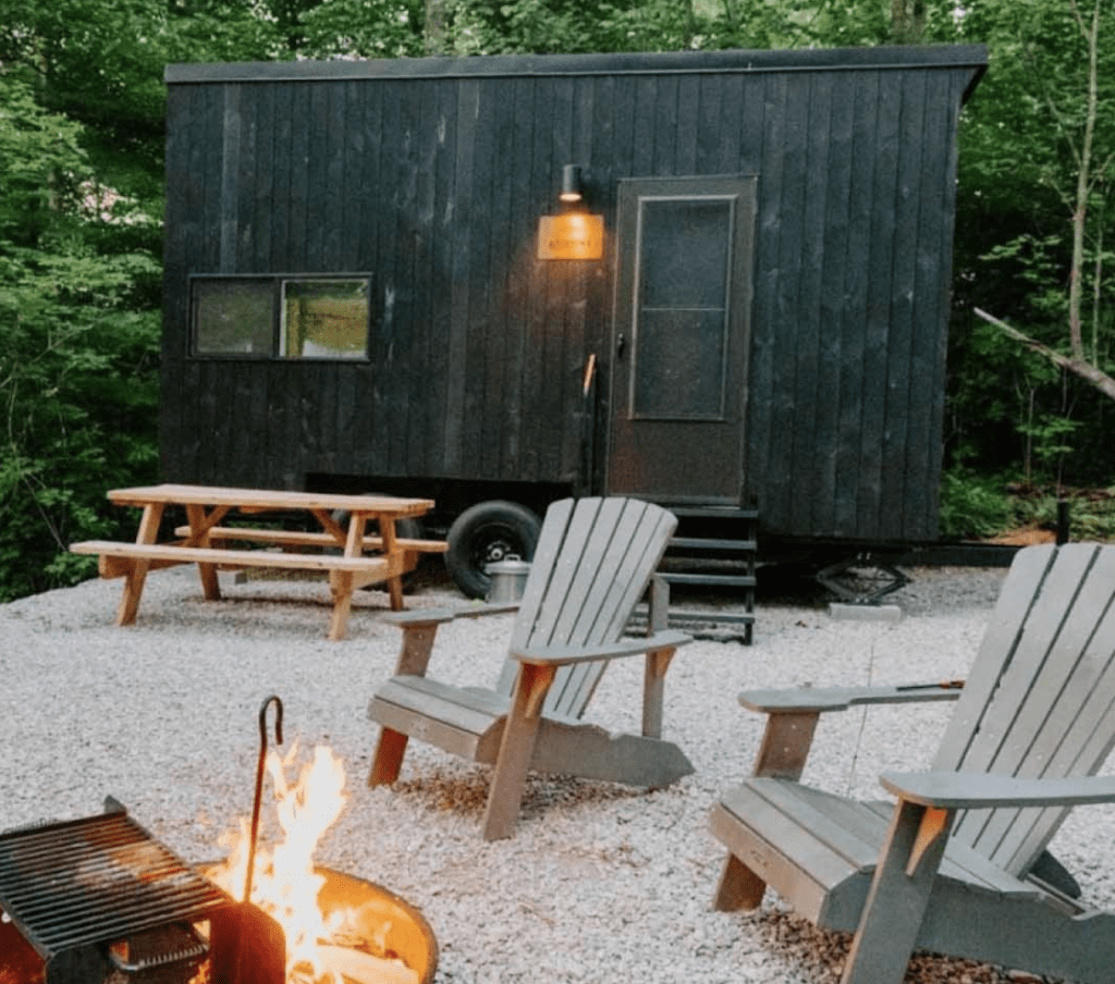 getaway tiny home with chairs around campfire as getaway christmas gift idea for women